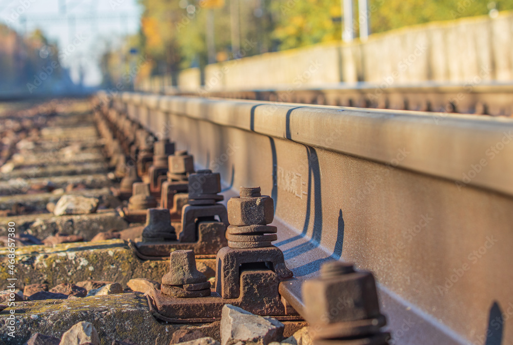 view of the rails from a low perspective, close-up of the rails and railway sleepers. view of the rails from a low perspective, close-up of the rails and railway sleepers.