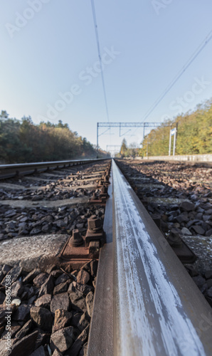 view of the rails from a low perspective, close-up of the rails and railway sleepers. © Micha