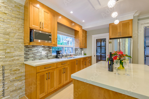 Modern, bright, clean, kitchen interior with stainless steel appliances in a luxury house