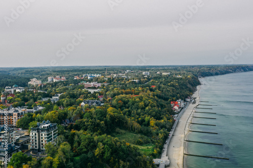Wallpaper Mural Panoramic aerial view of the Baltic Sea coast and the promenade in the resort town of Svetlogorsk, beach, Waves breaking on breakwaters, Old wooden ridges. Kaliningrad region. Torontodigital.ca