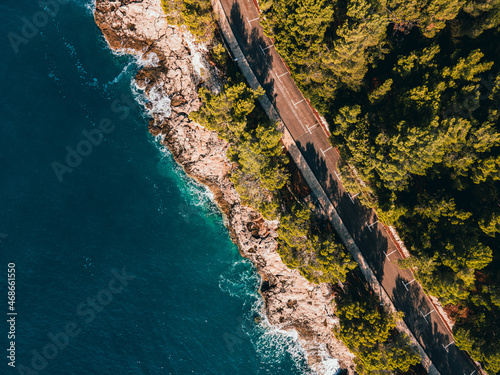  The waves of the Adriatic wash over the rocky shore. High quality photo. A photo from a drone of the rocky coast of the Adriatic Sea. bright colors of the sea in cloudy weather. Croatia, Pula