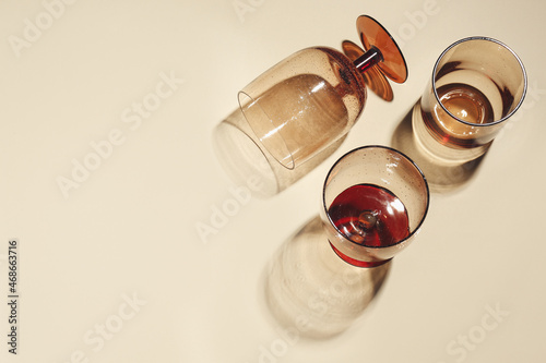 Glasses on beige background, flat lay. Space for text