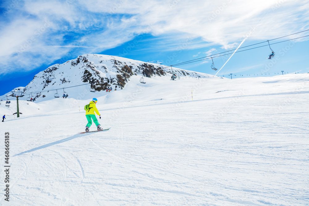 Girl snowboarder enjoys the winter ski resort.