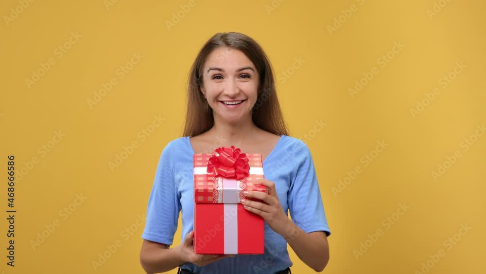Portrait of surprised woman opening red festive gift box with bow desired present posing isolated Portrait of surprised woman opening red festive gift box with bow desired present posing isolated