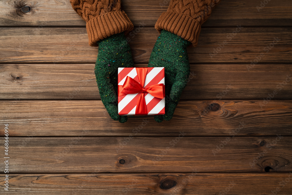 Christmas card with gift in the hands of a girl Christmas card with gift in the hands of a girl