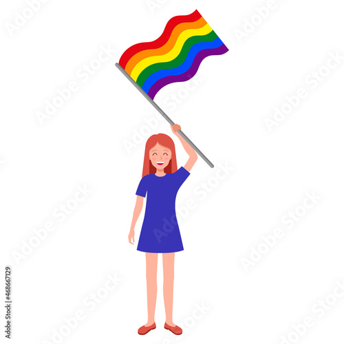 Redhead woman holding rainbow flag taking part in the pride parade.