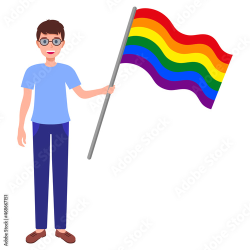 Brunette man with glasses holding big rainbow flag taking part in the pride parade.