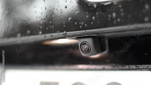 Rear view camera on a black car. Drops on the paint.