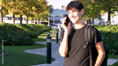 Young business student making a phone call while smiling, copy space, notebook student business concept, modern design business buildings