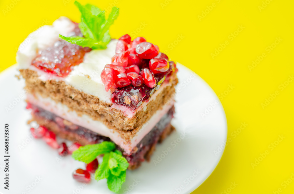 Colorful layered cream chocolate cake with cherry jam and pomegranate Colorful layered cream chocolate cake with cherry jam and pomegranate