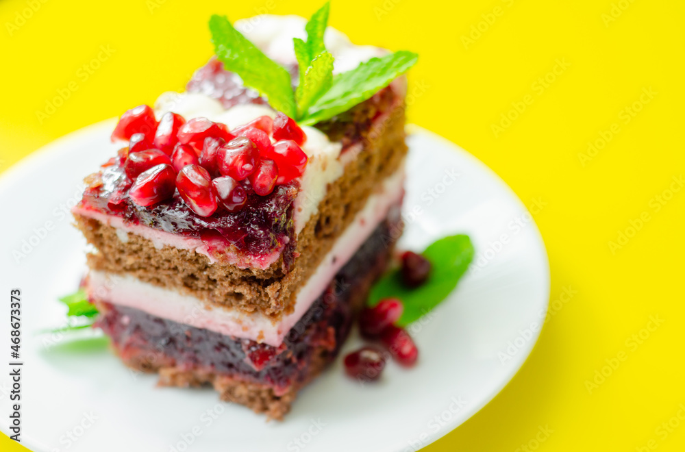 Colorful layered cream chocolate cake with cherry jam and pomegranate Colorful layered cream chocolate cake with cherry jam and pomegranate