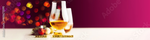 single malt  whisky in tasting glass on christmas background, colorful bokeh photo