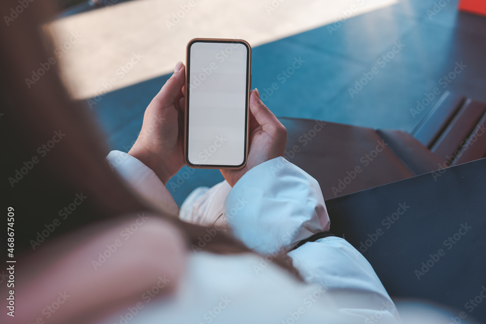 Close up of female hands holding credit card mockup and blank phone screen on the street, online shopping, place for your text Close up of female hands holding credit card mockup and blank phone screen on the street, online shopping, place for your text