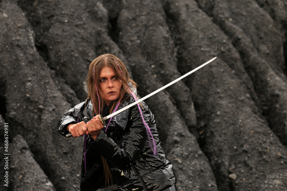 Woman with katana sword near coal