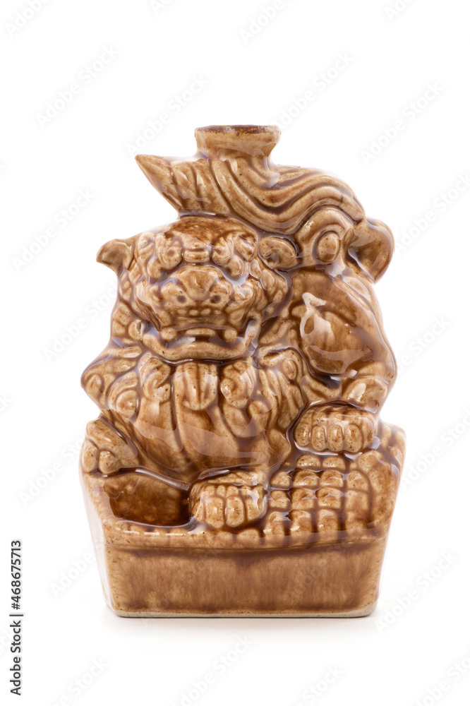 Shisa Lion ceramic old bottle isolated on white background.