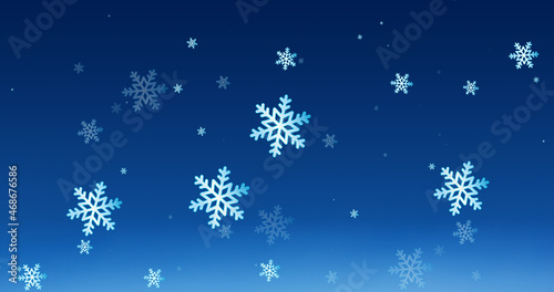 Image of snow falling over blue background at christmas