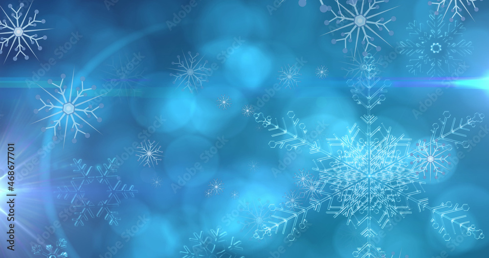 Image of christmas snowflakes falling over blue bokeh background Image of christmas snowflakes falling over blue bokeh background