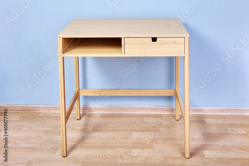 Bild auf Leinwand Console table with storage or writing desk against light blue wall in lounge room