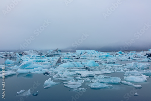 Iceland Jökulsárlón Iceberg Lagoon glacier water with floating blue icebergs and glacier with fog