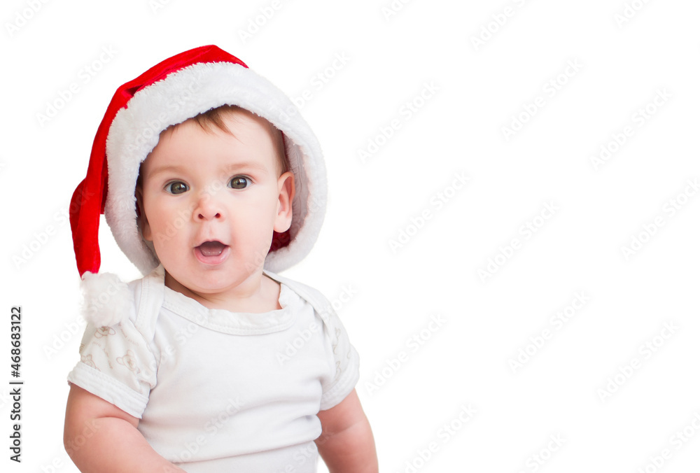 charming baby in red santa hat on white isolated background. Cute baby in a Christmas look with a smile on his face charming baby in red santa hat on white isolated background. Cute baby in a Christmas look with a smile on his face