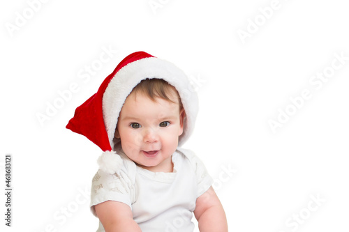 Beautiful baby girl in santa hat on white isolated background. Christmas or New Year concept. A wonderful child.