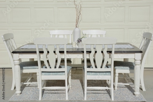Farmhouse table with chairs chalk painted white with modern centerpiece. Modern farm house look.