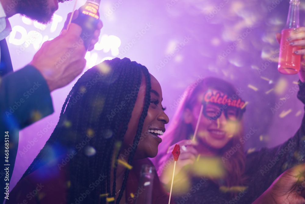 Happy group of friends dancing on a party in a club Happy group of friends dancing on a party in a club