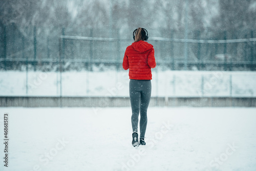 Attractive and athletic young woman working out on a cold winter day