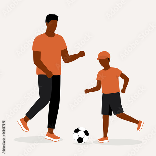 Black Father And Son Playing Soccer Together.