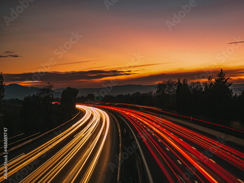 sunset on highway with car lights
