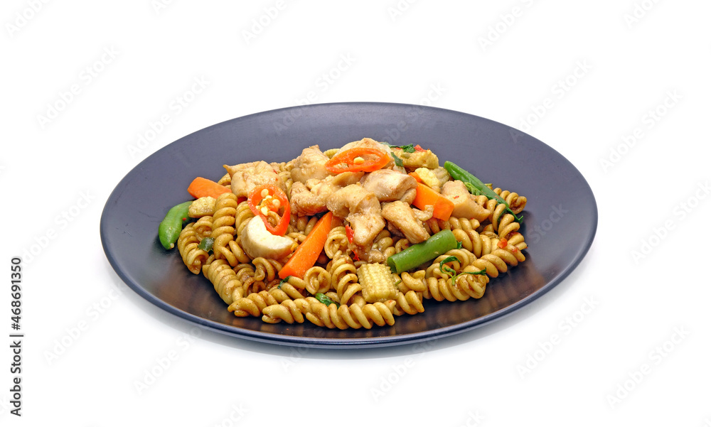 Thai Spicy Fusilli with chicken and herbs isolated on white background. Drunken Fusilli with chicken, Thai style pasta. Fusion food, Thai - Italian cuisine Thai Spicy Fusilli with chicken and herbs isolated on white background. Drunken Fusilli with chicken, Thai style pasta. Fusion food, Thai - Italian cuisine