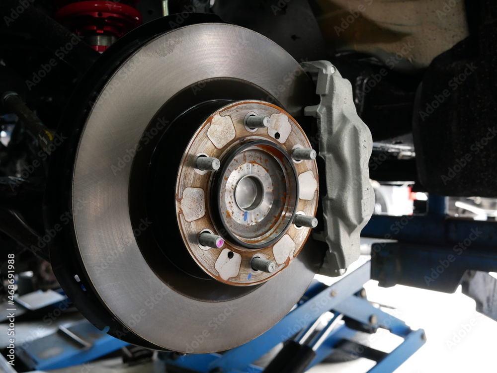 maintaining car wheel brake disc at repair service station.
maintaining car wheel brake disc at repair service station.