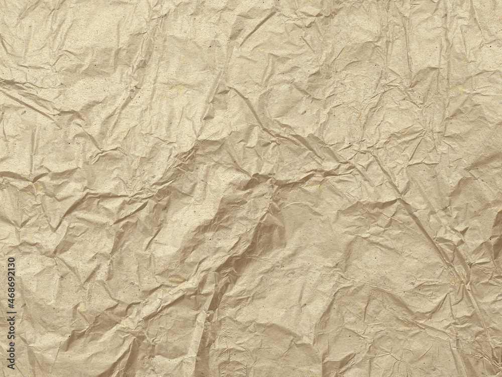 Crumpled cardboard in sepia tones. Old paper texture. Destroyed surface.