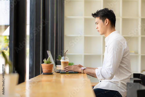 Young Asian men, future students for self or personal learning ideas. Online students at coffee shops with books and laptops.