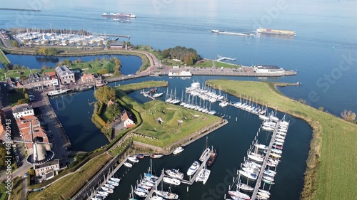 Dutch fortress city of Willemstad in North Brabant with a view of the old harbor. Industry moves in the background of goods via water and rivers.