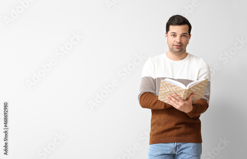 Young man with book and ear...