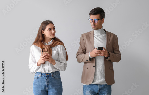 Quarreled young couple usin...