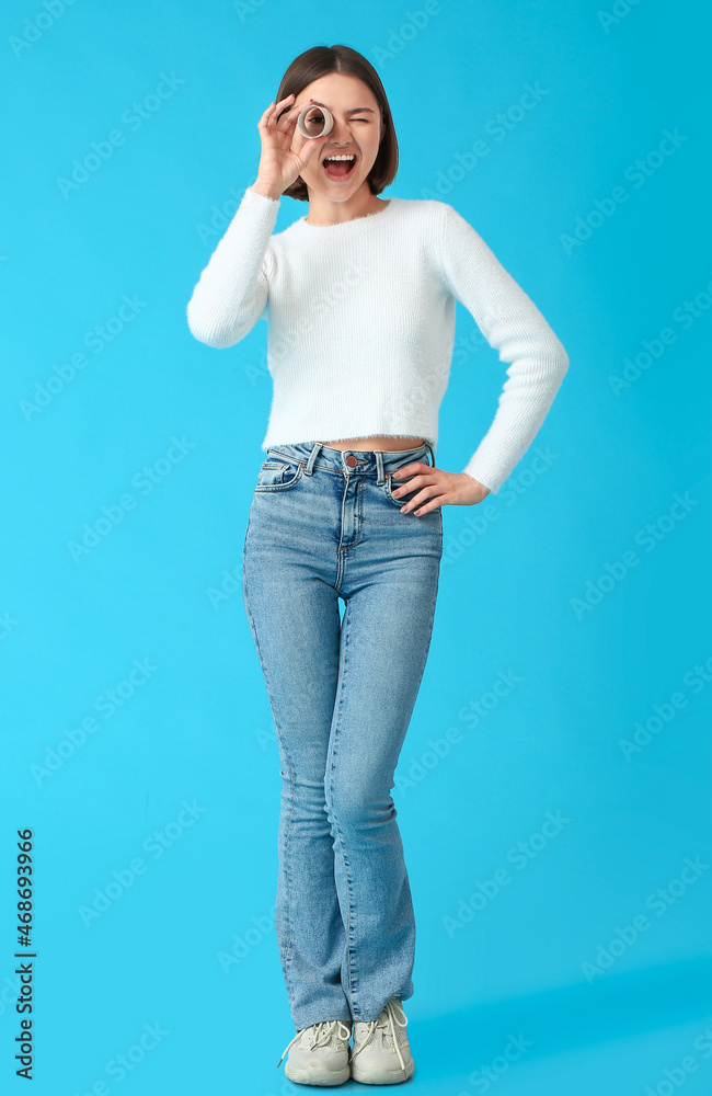 Young woman with cardboard tube from toilet paper on color background Young woman with cardboard tube from toilet paper on color background
