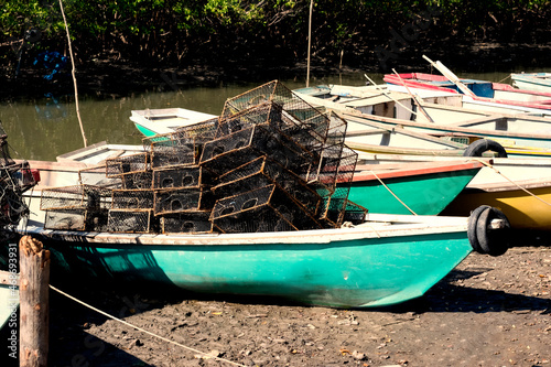 Canoes and colorful boats docked on the Paraguacu River photo