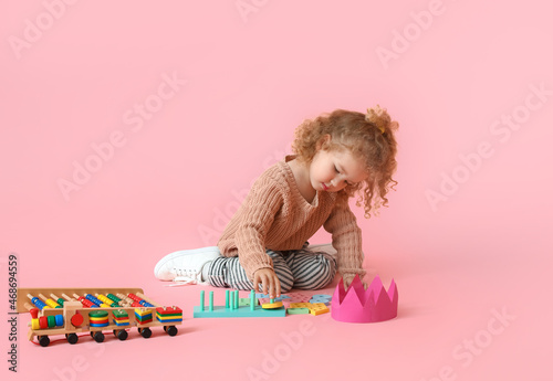 Cute baby girl with toys on...