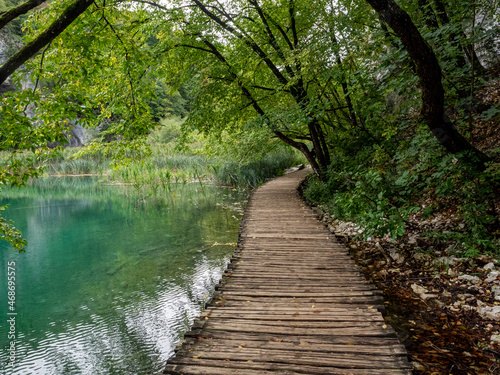 Fototapeta Naklejka Na Ścianę i Meble -  Wooden walkway twisting over shallow lake area of Plitvice Lakes District, Croatia.