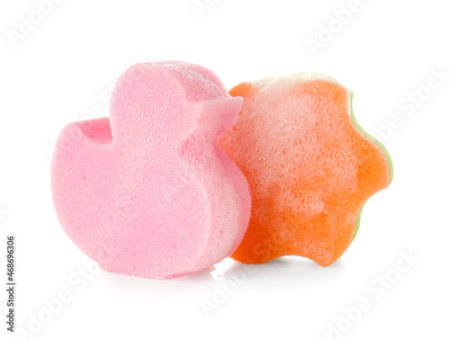 Duck and star shaped bath sponges with foam on white background