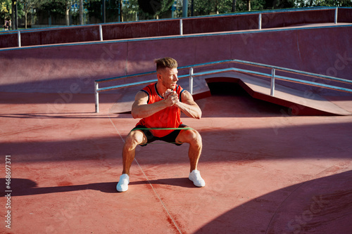 athletic man in red jersey workout exercise pumped up body © VICHIZH