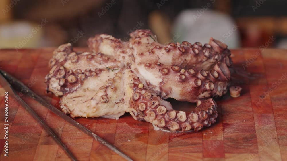 Close up dolly in and out shot of a cooked eight legged molluscs octopus with hot steam visibly appearing from freshly cooked octopus. Close up dolly in and out shot of a cooked eight legged molluscs octopus with hot steam visibly appearing from freshly cooked octopus.