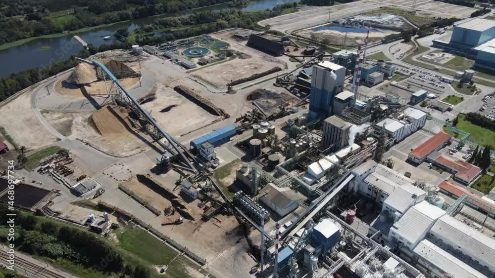 Aerial view of a paper production factory, drone moving forwards over the factory buildings. 4K, 60fps. Aerial view of a paper production factory, drone moving forwards over the factory buildings. 4K, 60fps.