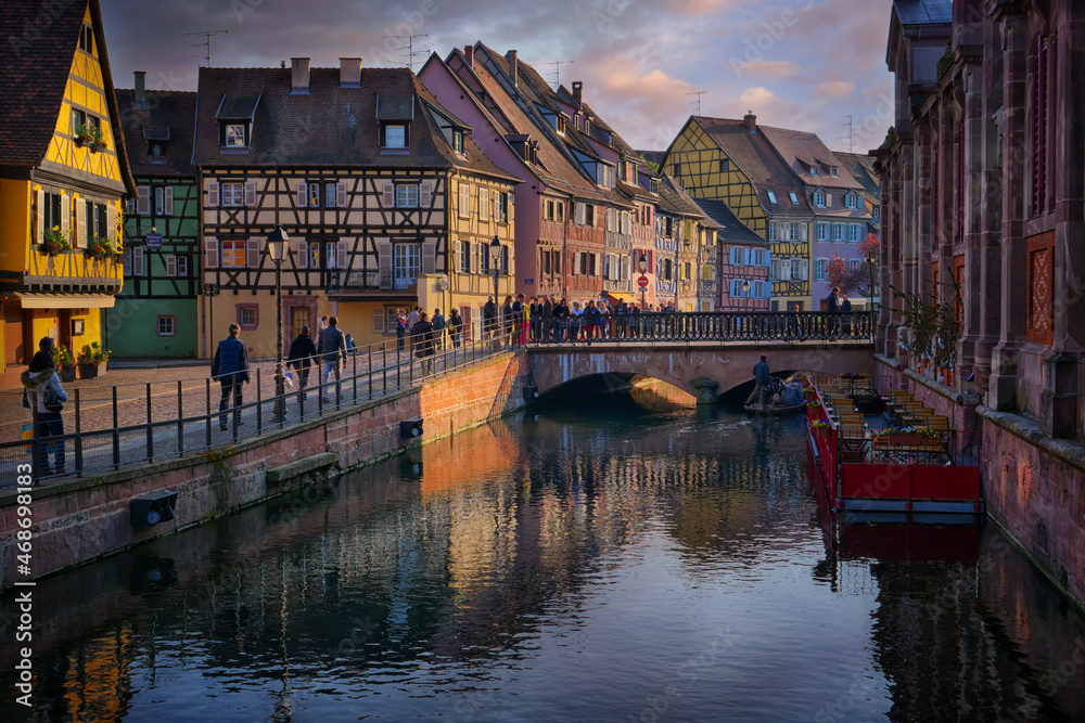 Sunset on a medieval city waterway in Alsace
