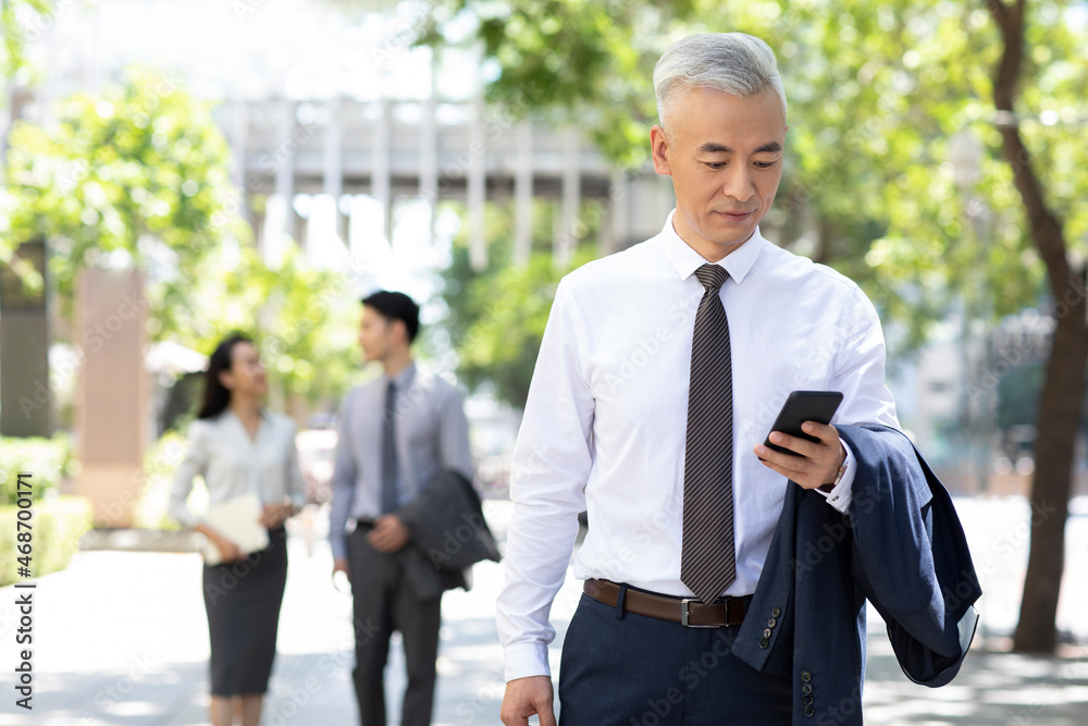 Confident businessman using smart phone Confident businessman using smart phone