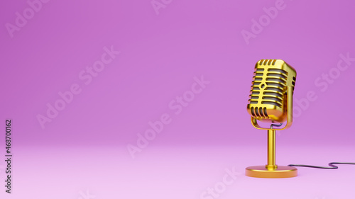 Golden vintage microphone on pink background