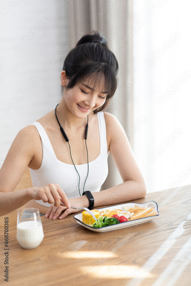 Young Chinese woman having breakfast at home Young Chinese woman having breakfast at home