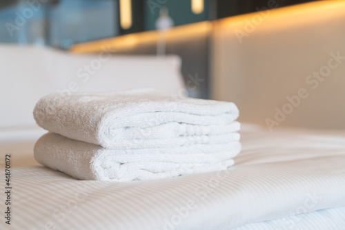 white shower towel on bed photo